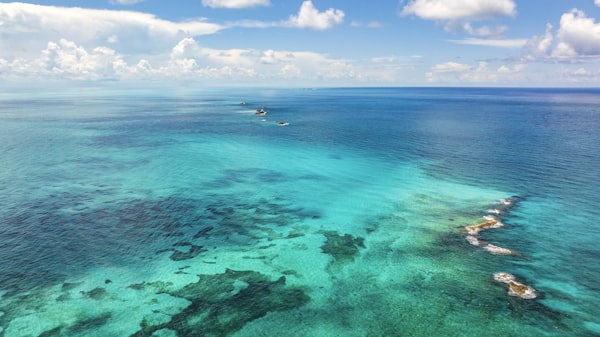 Aerial view of turquoise Caribbean waters with boats and small islands