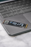 A close up of a laptop keyboard with a stick on it