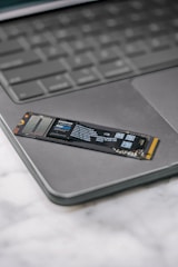 A close up of a laptop keyboard with a stick on it