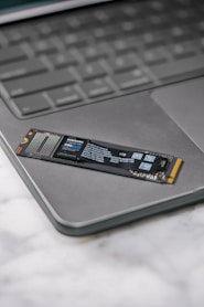 A close up of a laptop keyboard with a stick on it