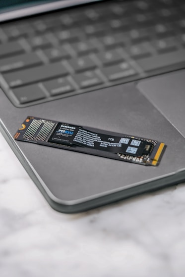 A close up of a laptop keyboard with a stick on it