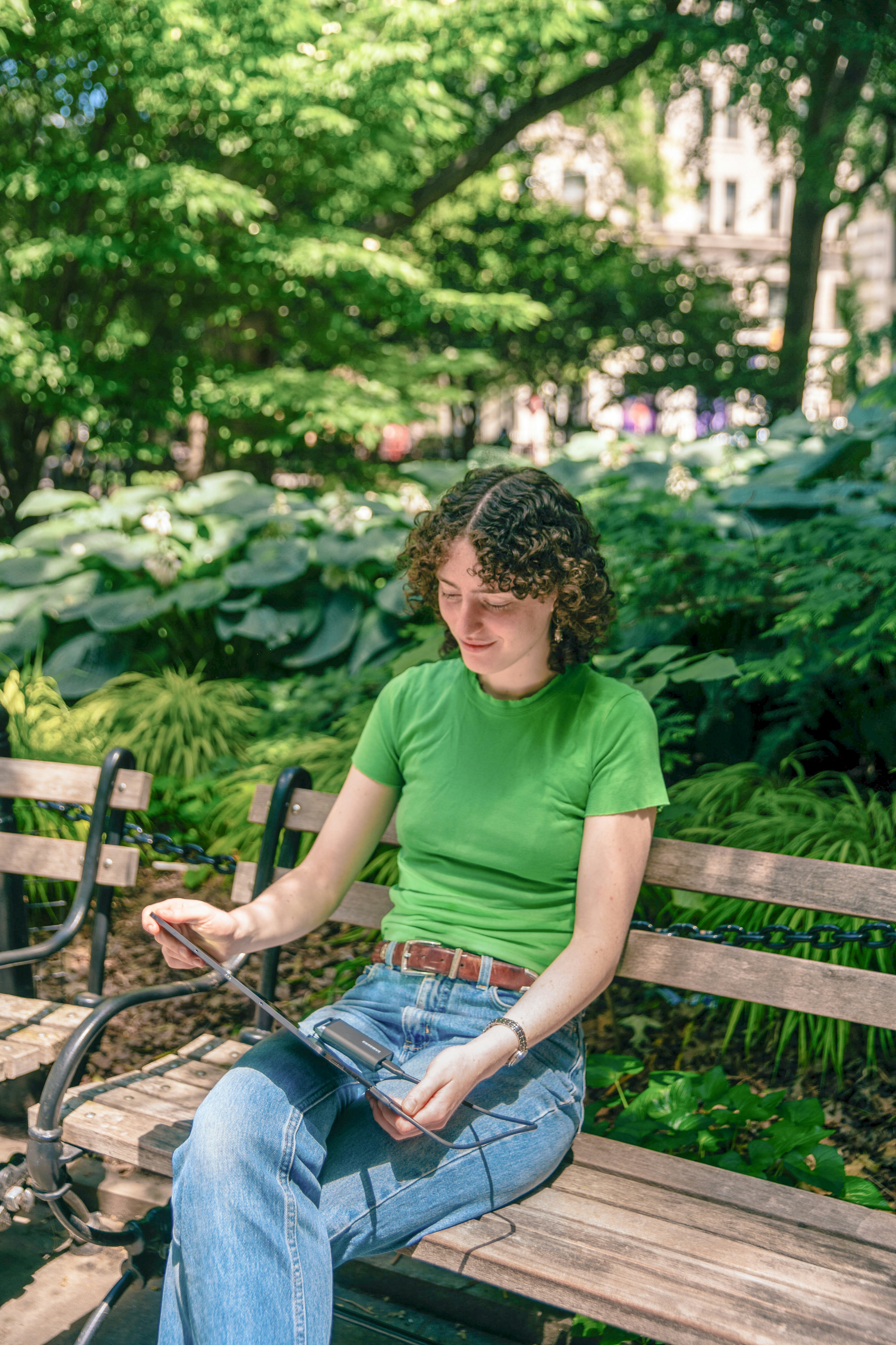 A woman sitting on a bench in a park