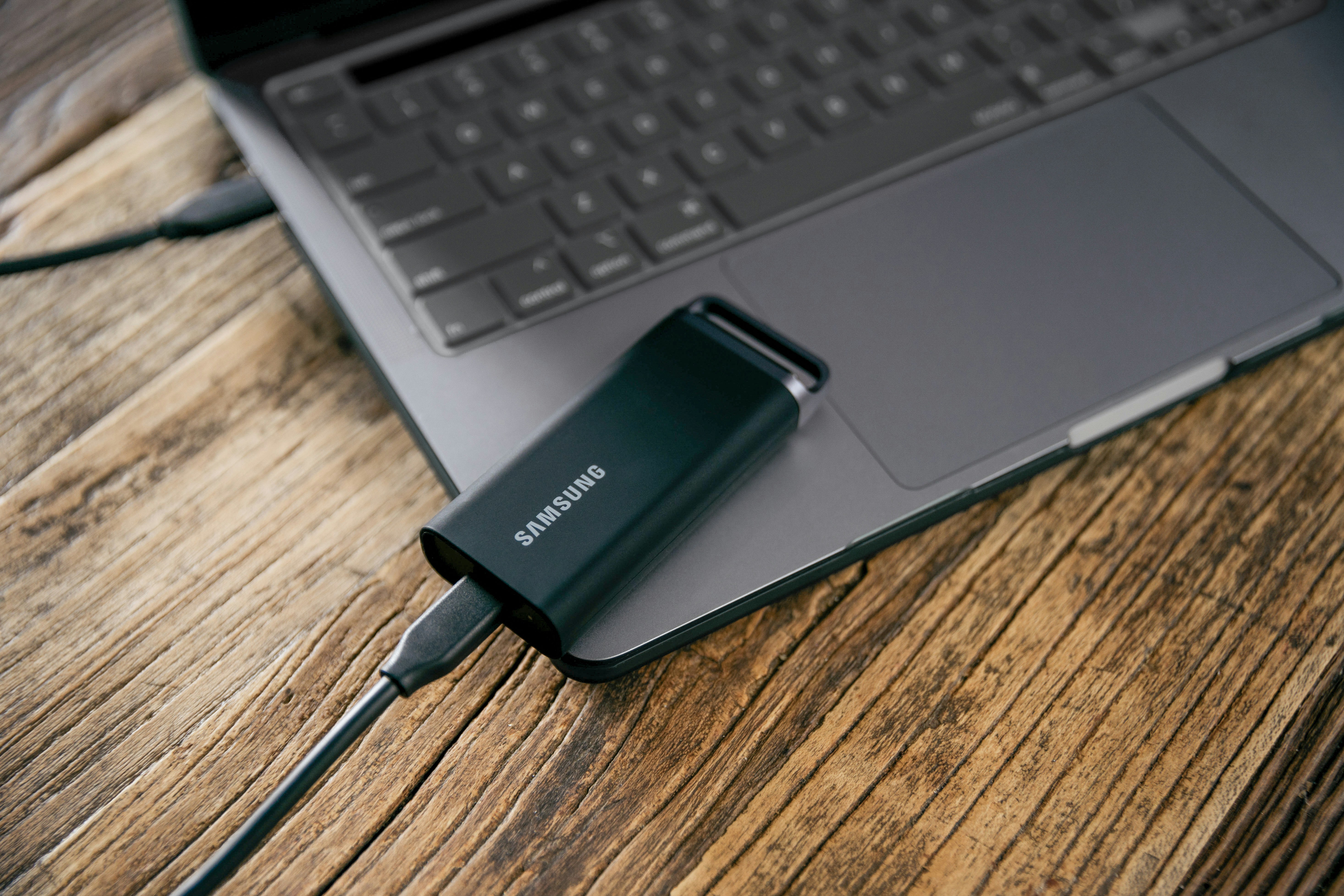 A laptop computer sitting on top of a wooden table