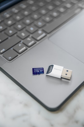A usb stick sitting on top of a laptop computer