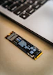 A close up of a laptop keyboard and a small piece of circuit board