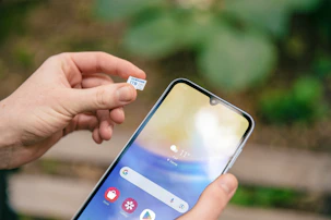 A person holding a cell phone in their hand