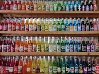 A wooden shelf filled with lots of bottles