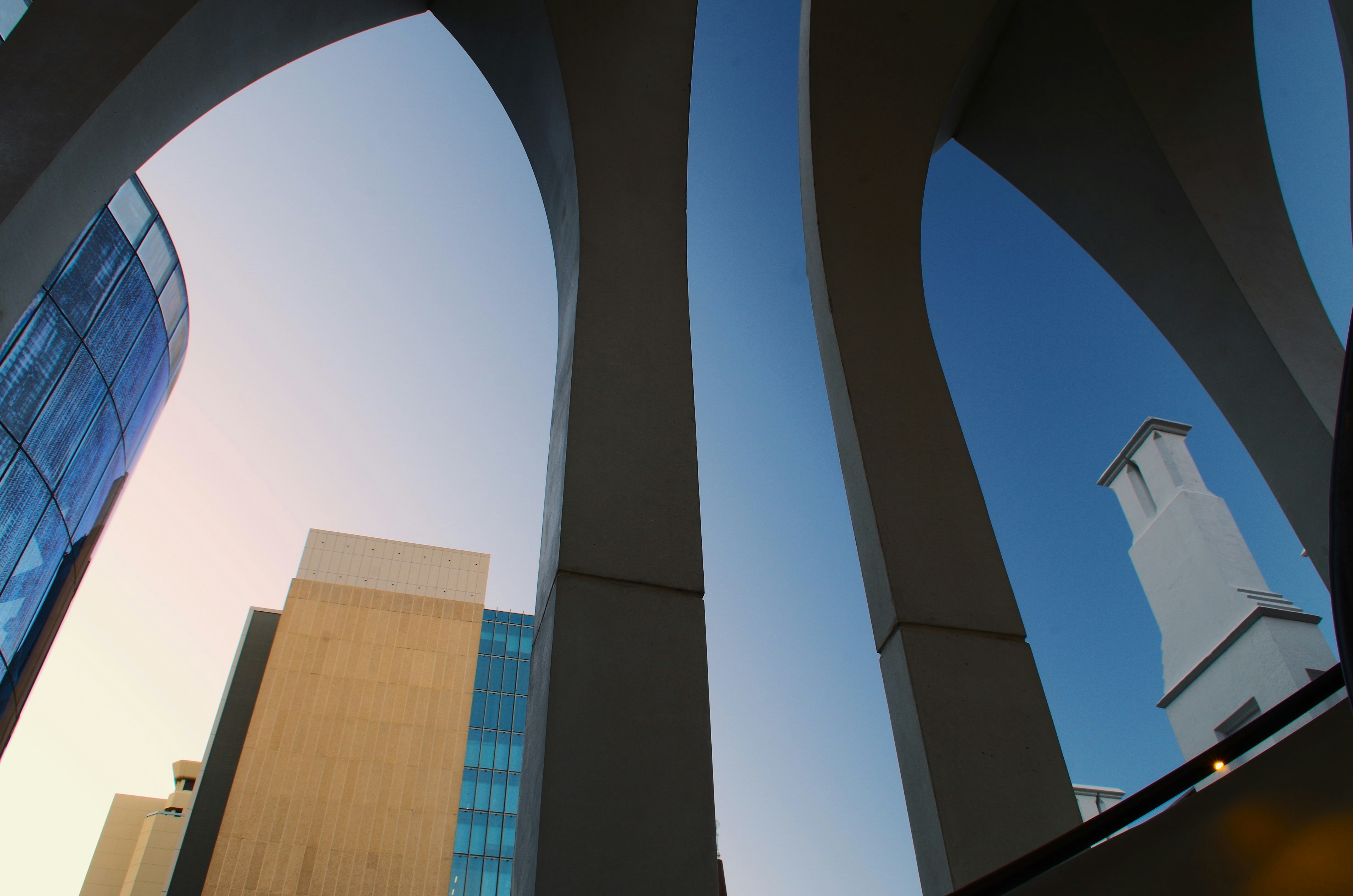 A view of a building through the arches of a building photo – Free ...