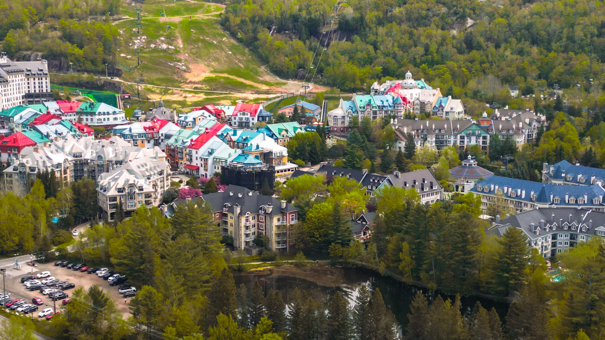 An aerial view of the colorful roofs of the Mont-Tremblant resort village among green trees