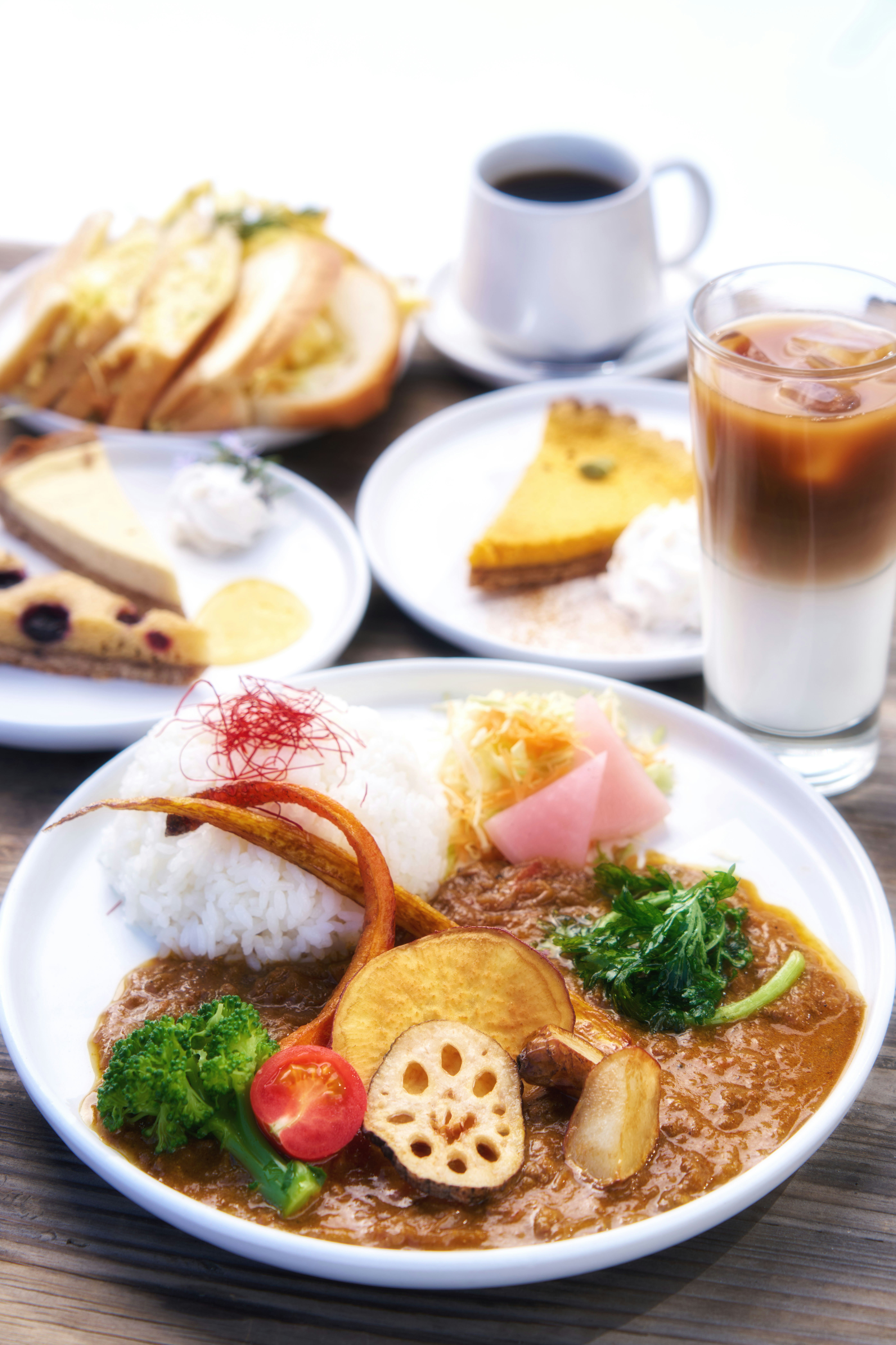 A wooden table topped with plates of food