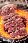A close up of meat cooking on a grill