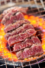 A close up of meat cooking on a grill