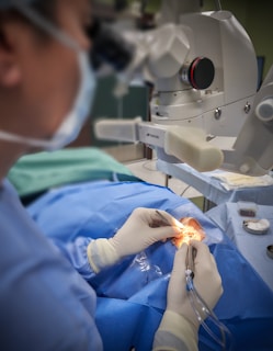 A person in a surgical gown is performing surgery