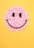 A smiley face made out of flowers on a yellow background