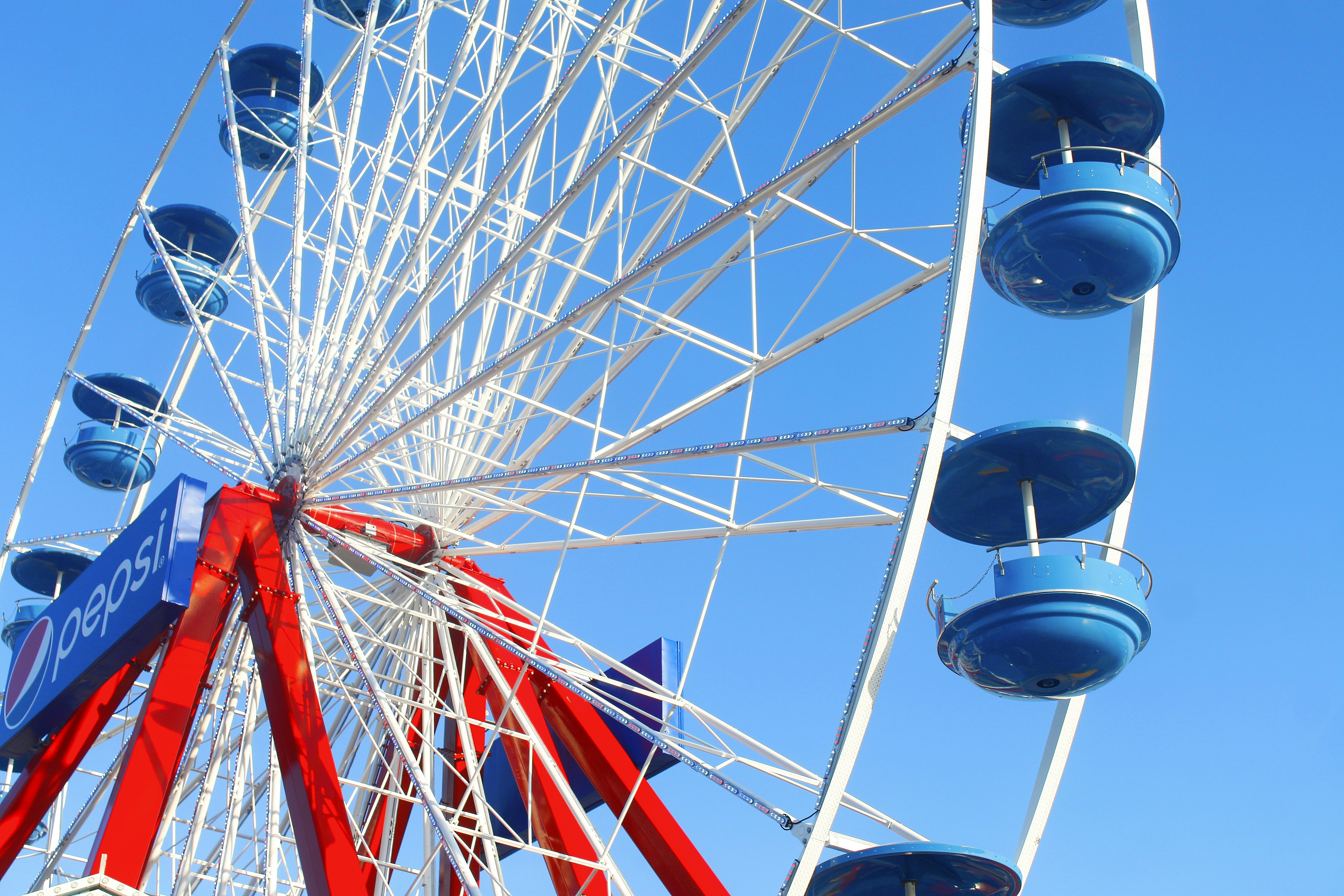 A ferris wheel with blue sky in the background
