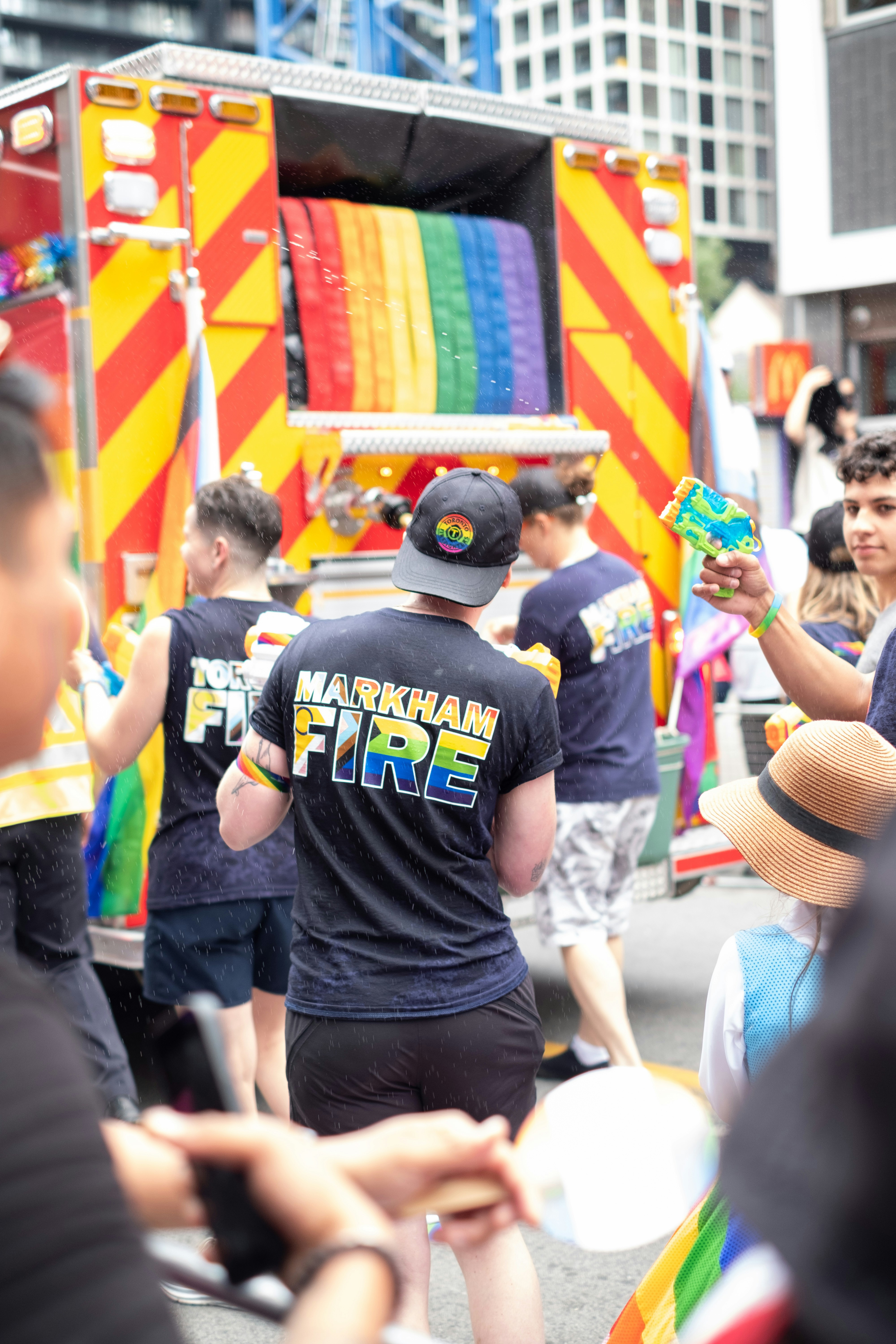 A group of people walking down a street next to a truck