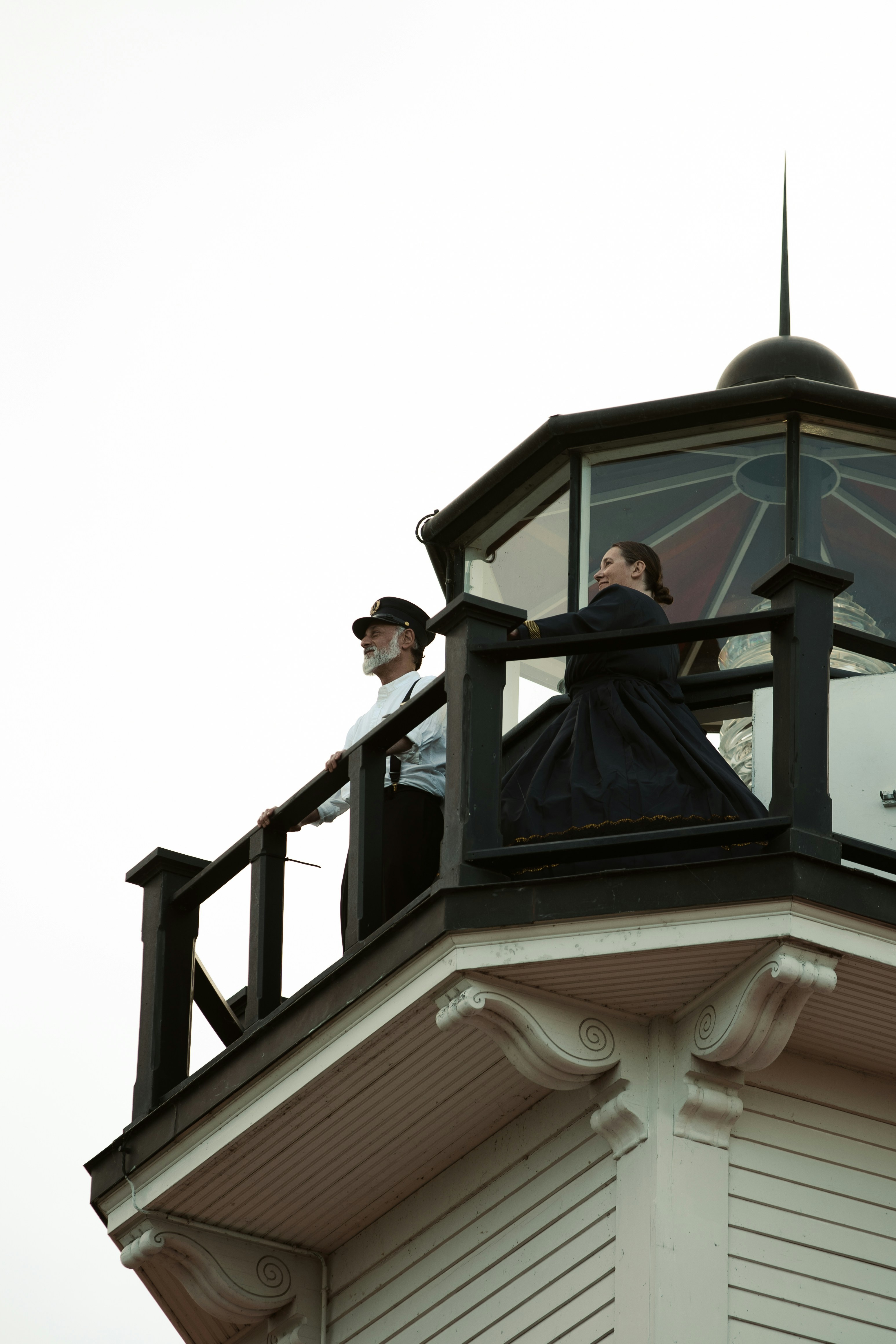 A couple of people standing on top of a tower