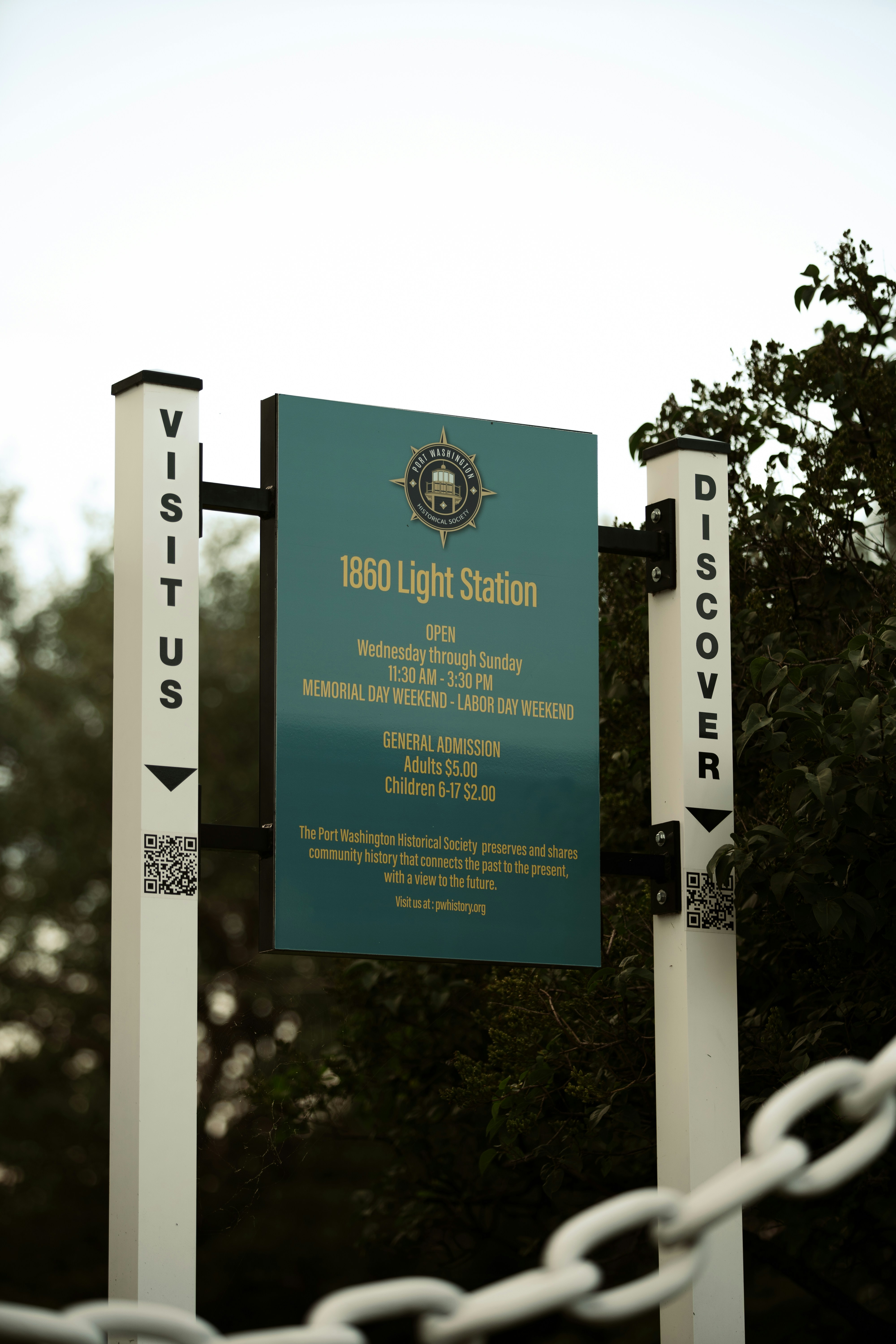 A sign is posted on a chain link fence