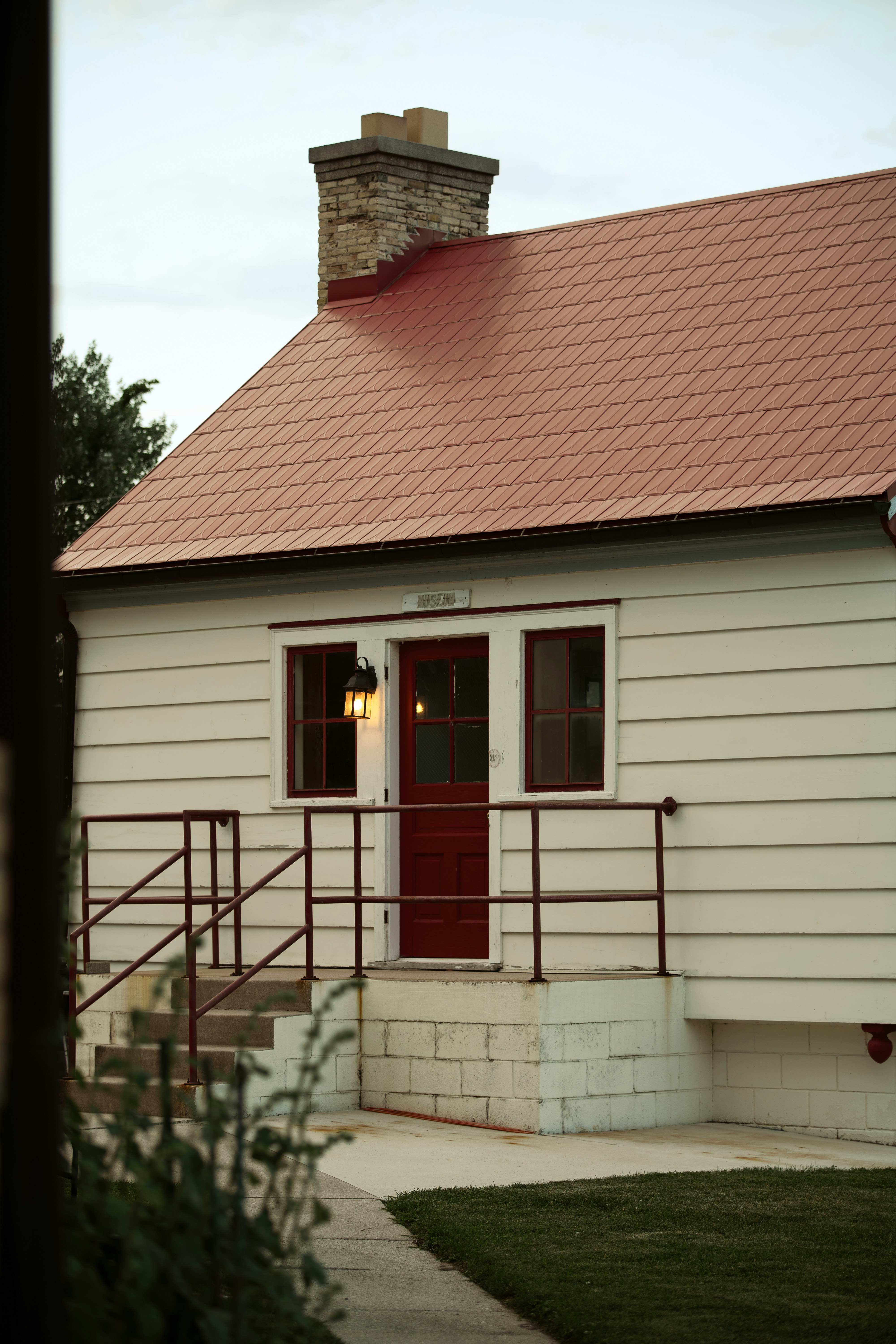 A small white house with a red roof