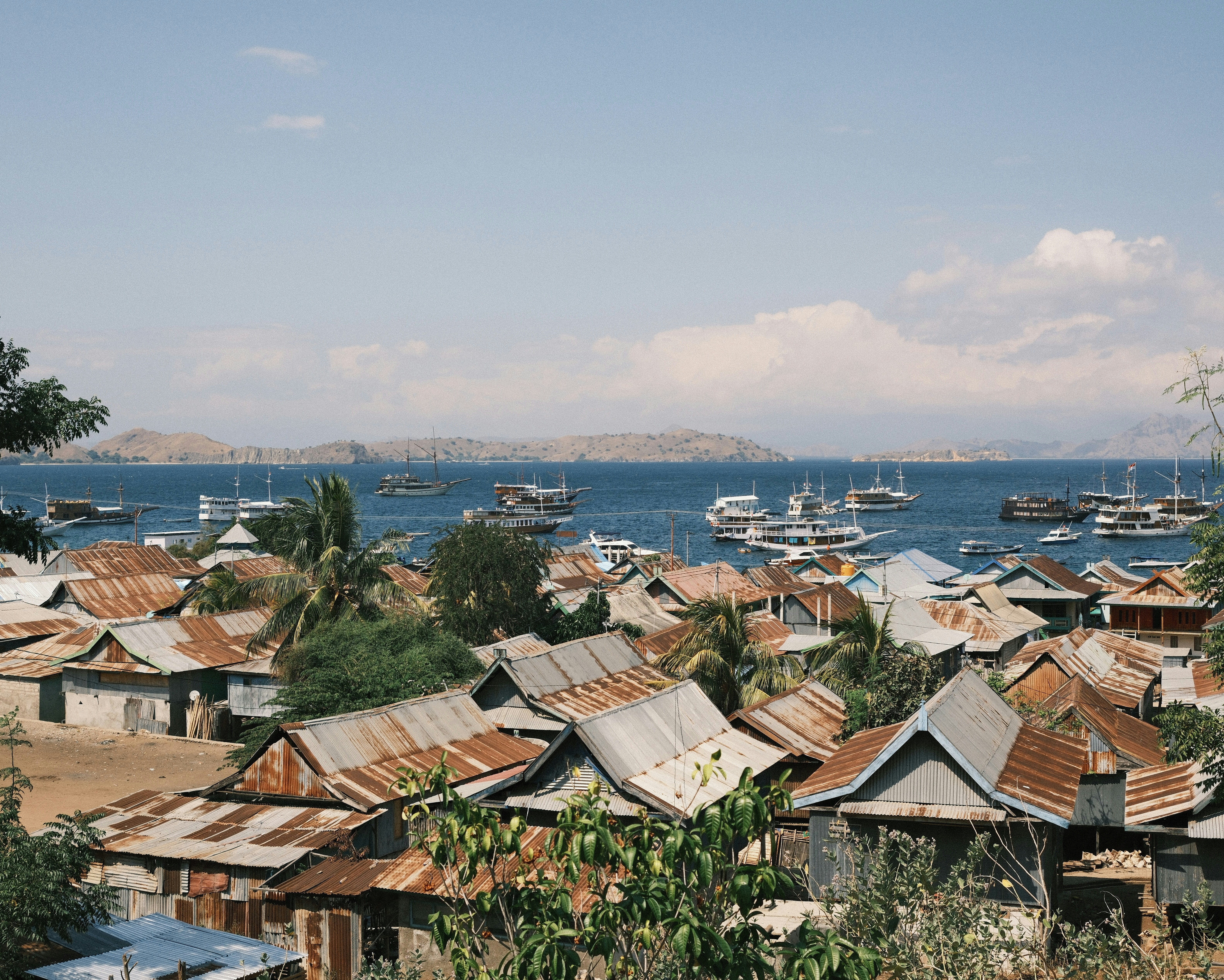 A group of boats floating on top of a body of water