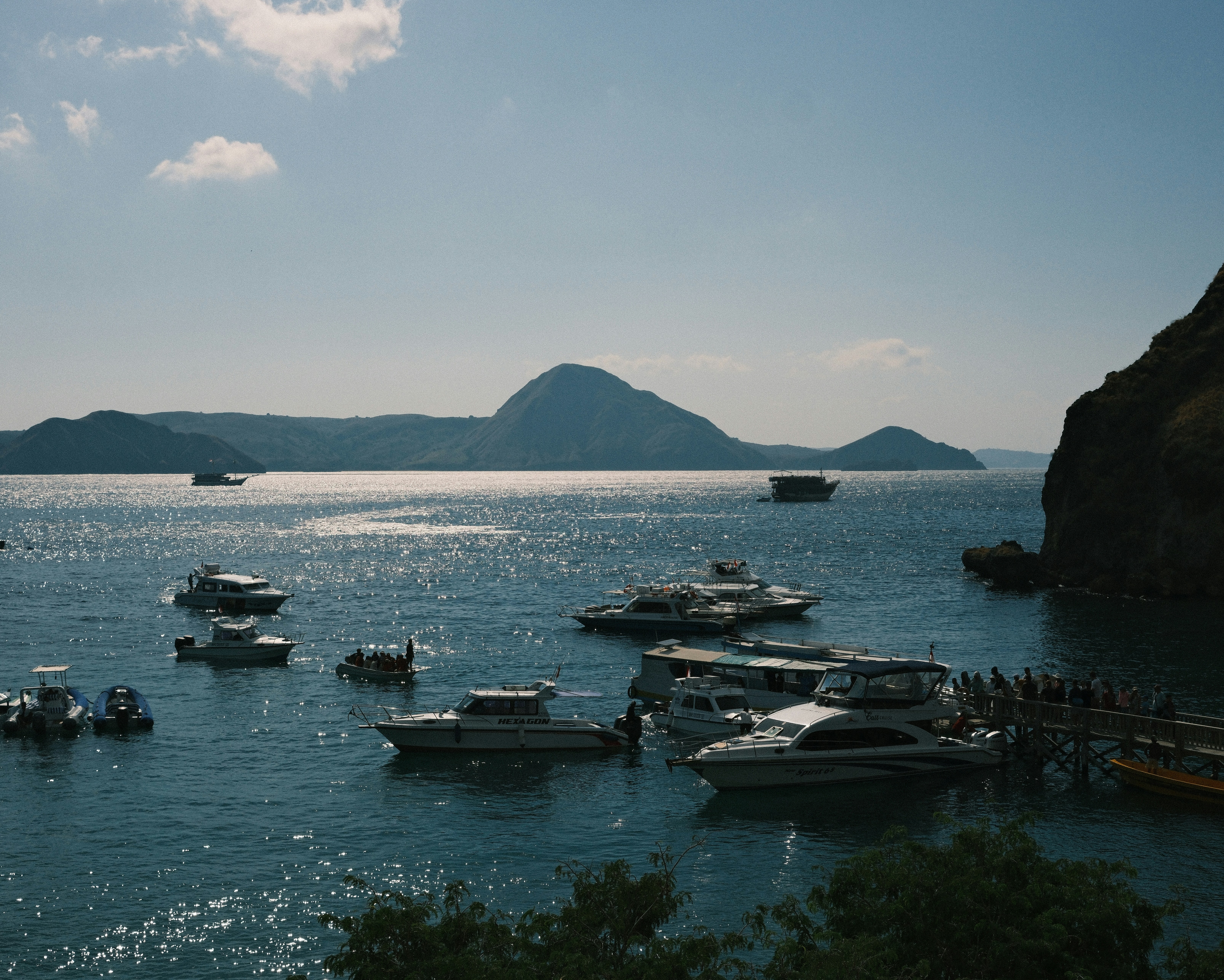 A group of boats floating on top of a body of water