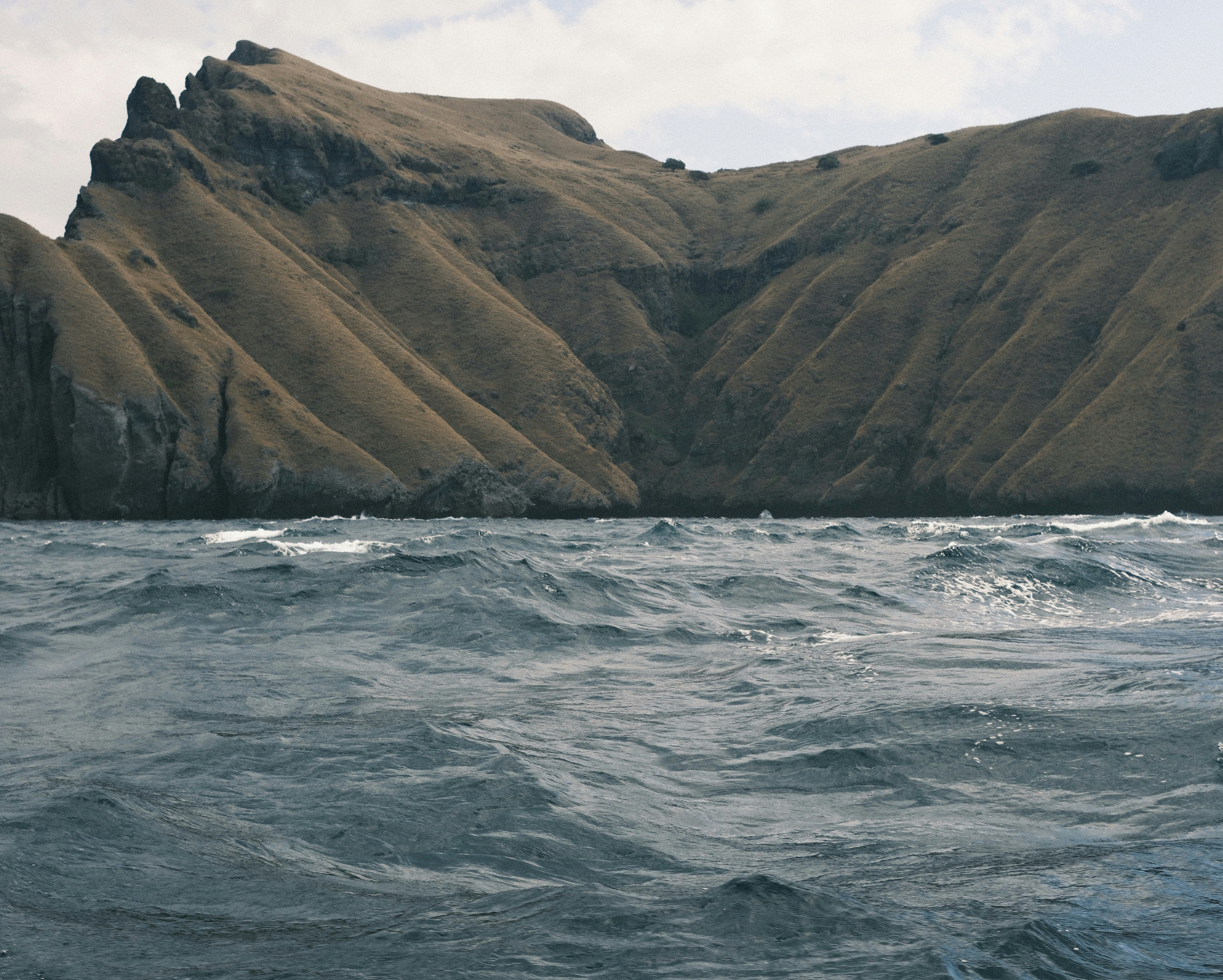 A large body of water with a mountain in the background