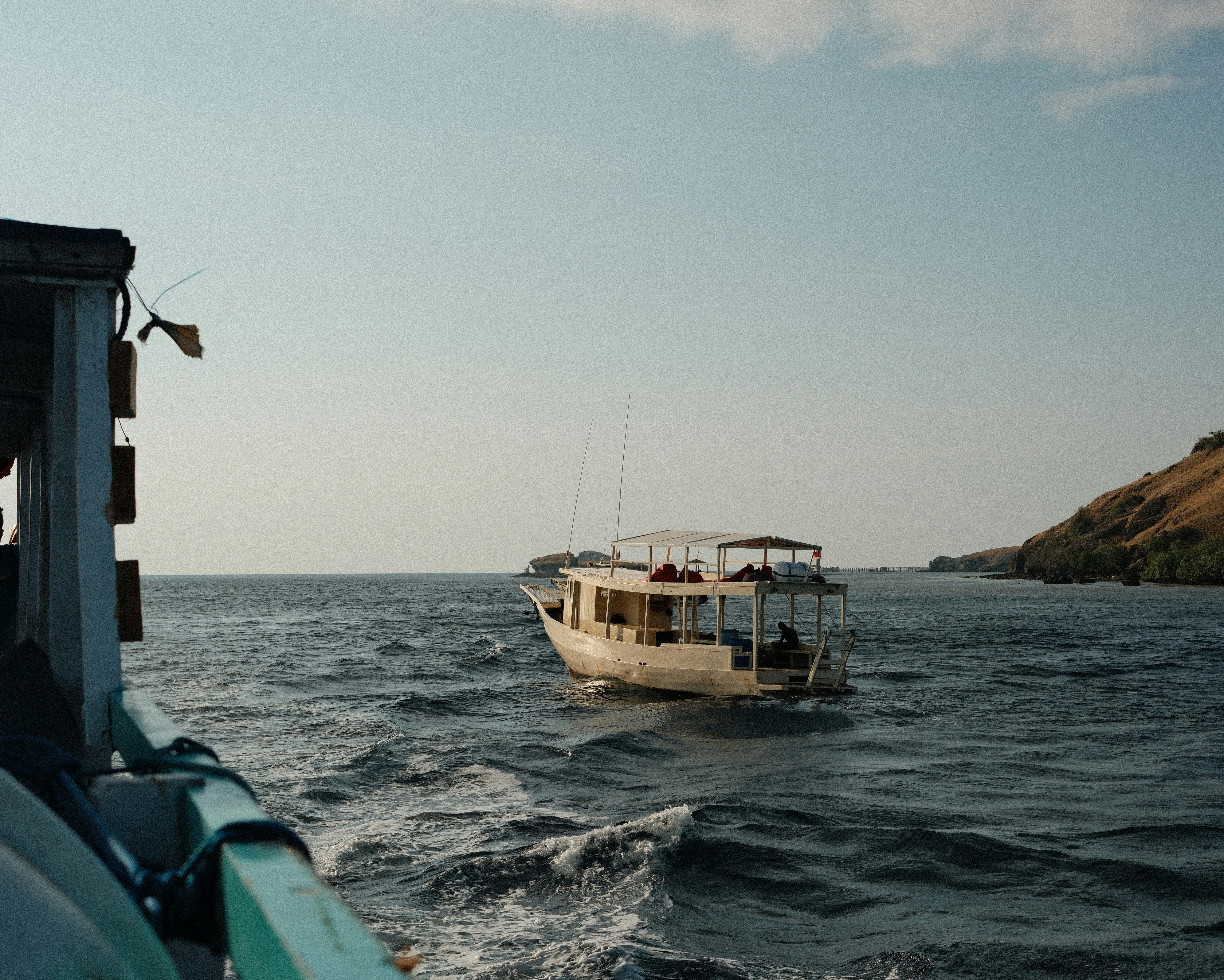 A small boat in the middle of a body of water
