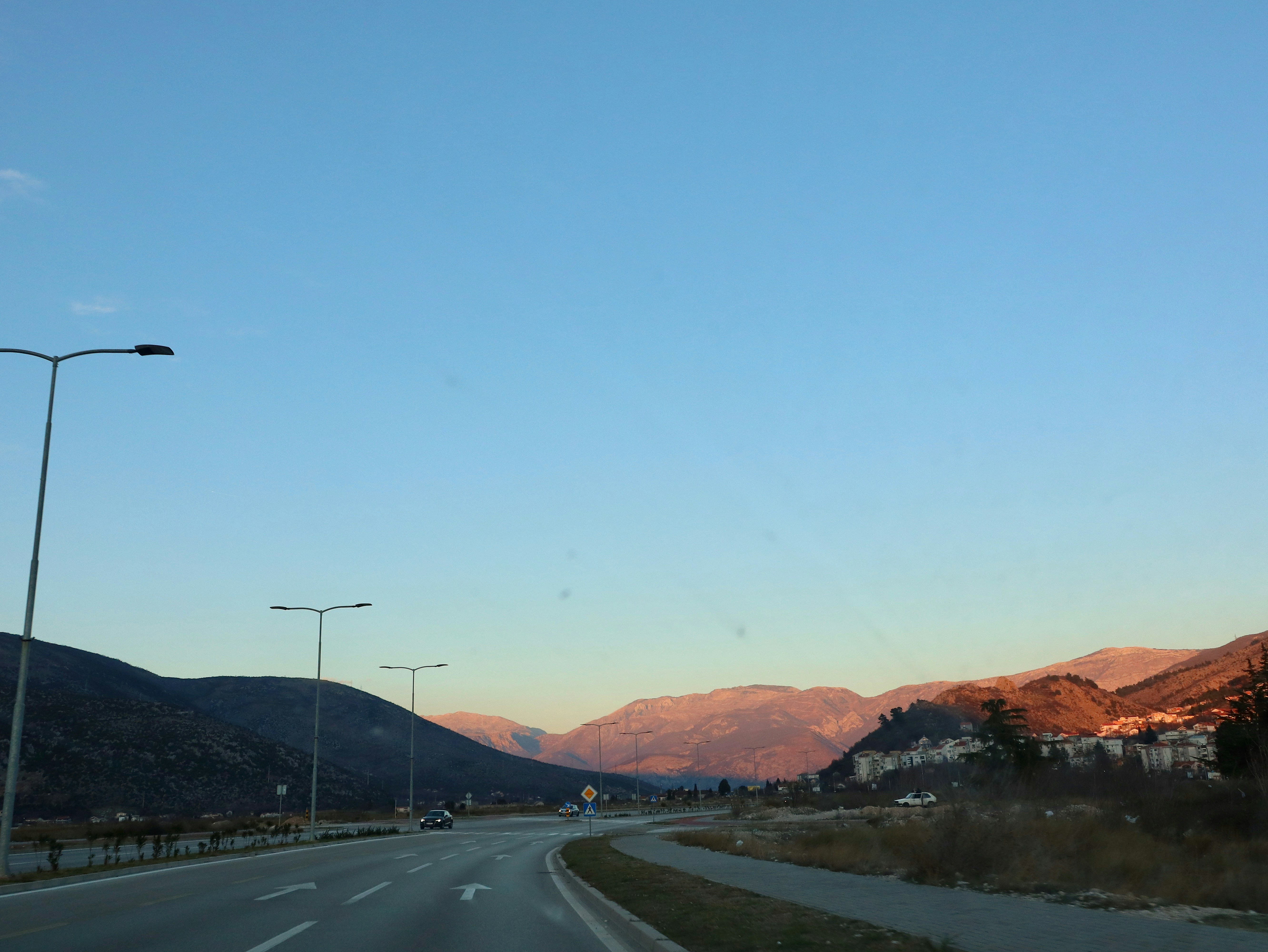 A view of a road with mountains in the background photo – Free Blue ...