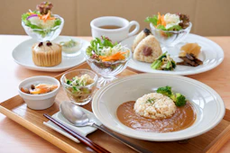 A wooden table topped with plates of food