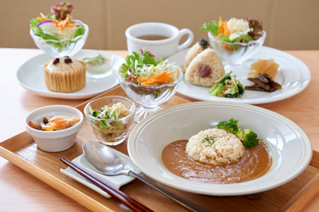 A wooden table topped with plates of food