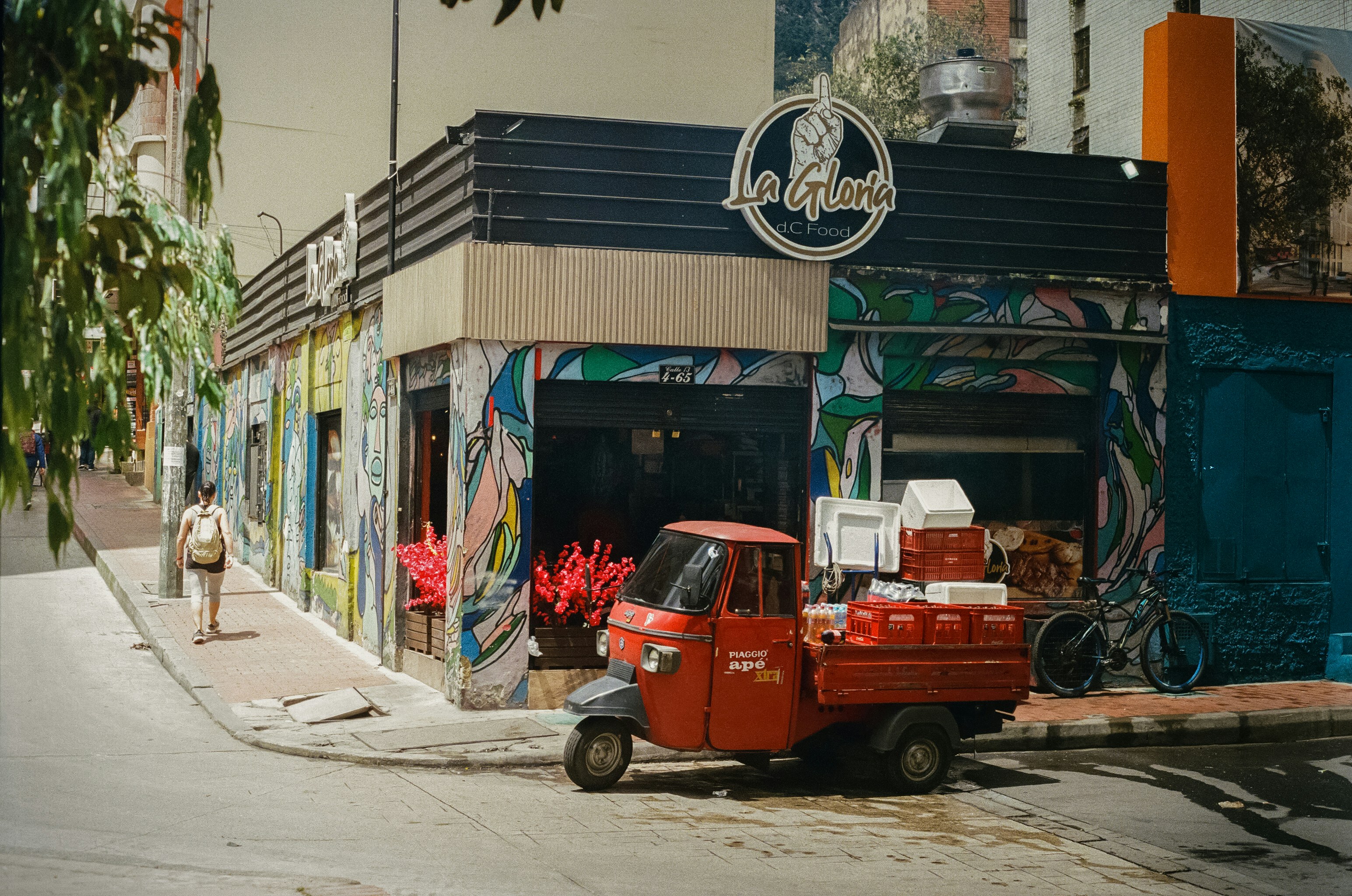 A red truck parked in front of a building