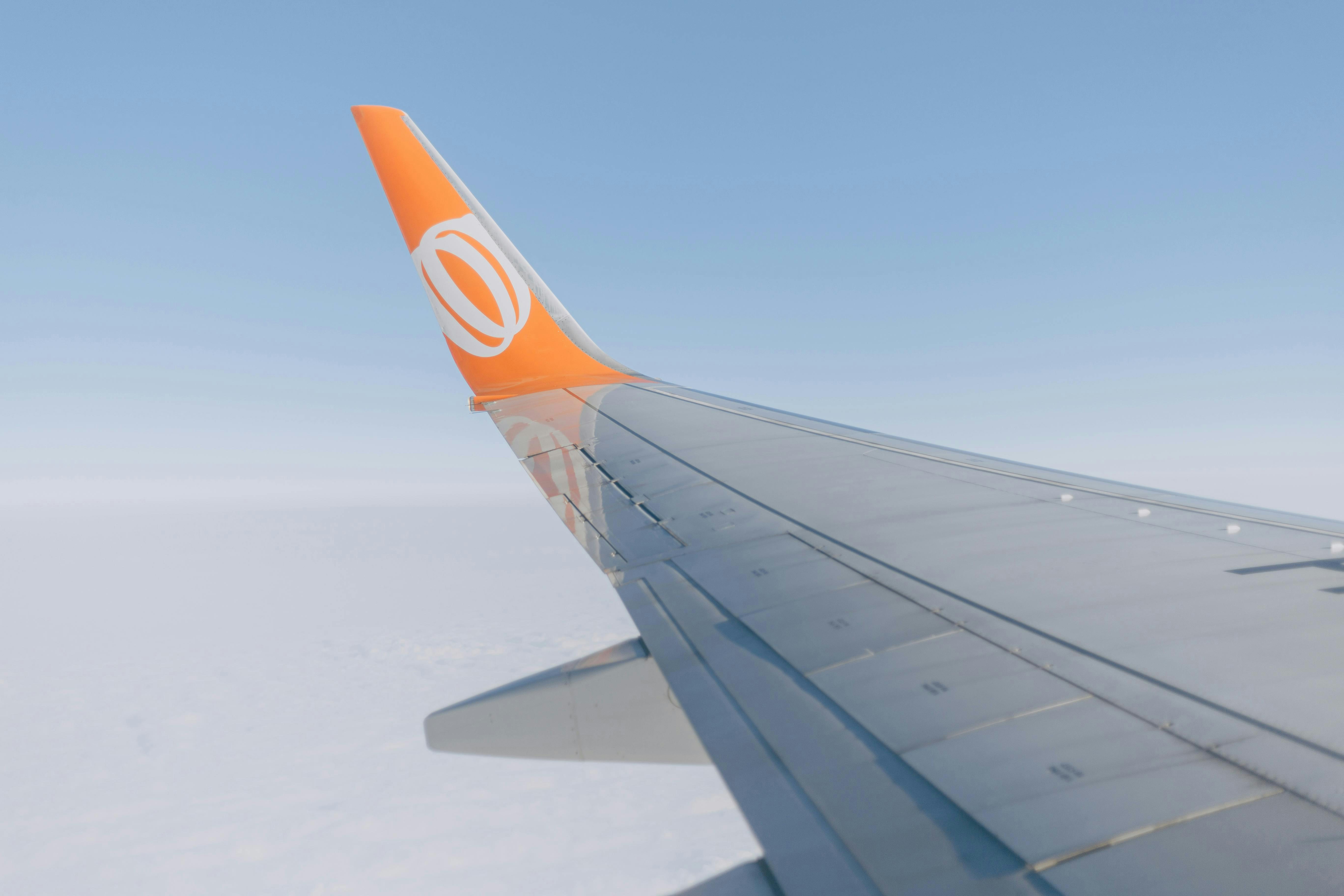 The wing of an airplane in the sky