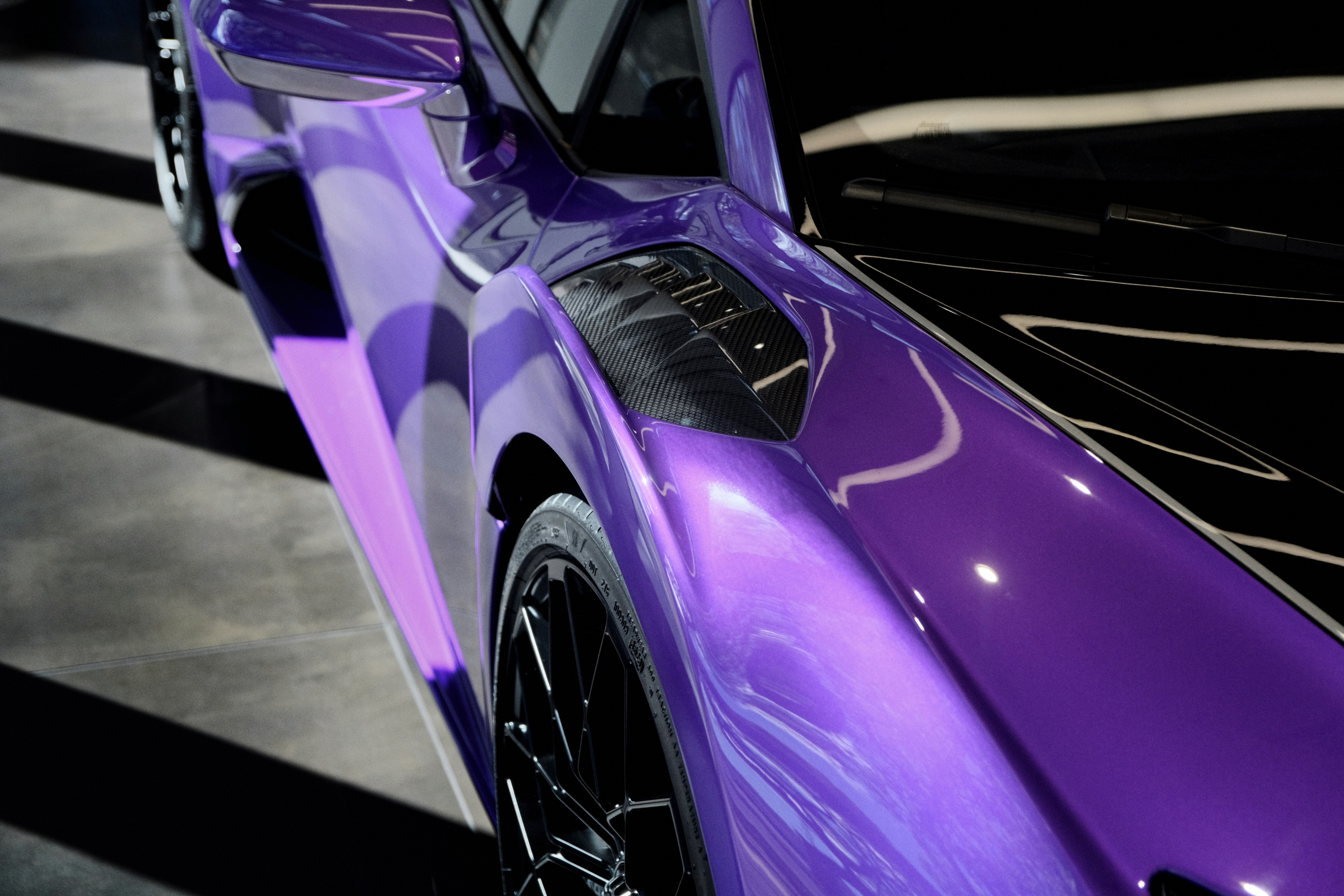 A purple sports car parked in a parking lot