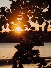 The sun is setting over a body of water