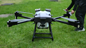A man standing next to a black and white flying device