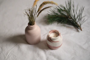 A couple of vases sitting on top of a bed