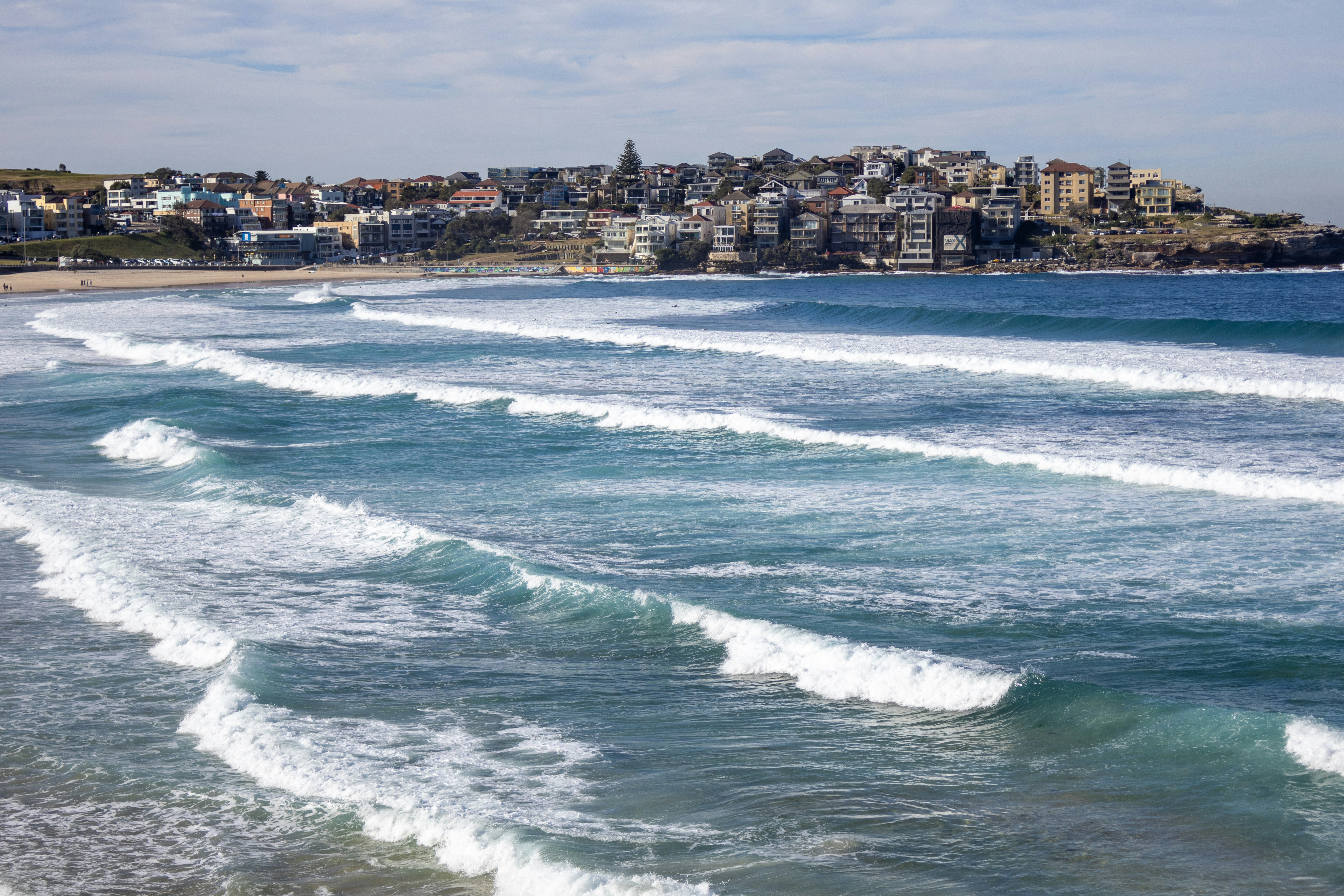A view of a beach with a city in the background