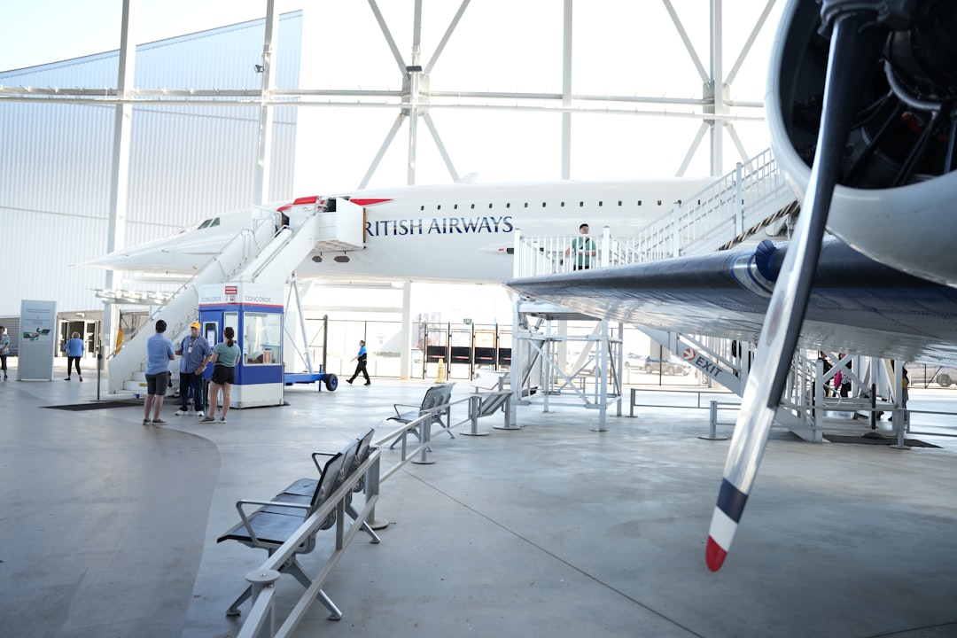 A large jetliner sitting inside of a hangar,