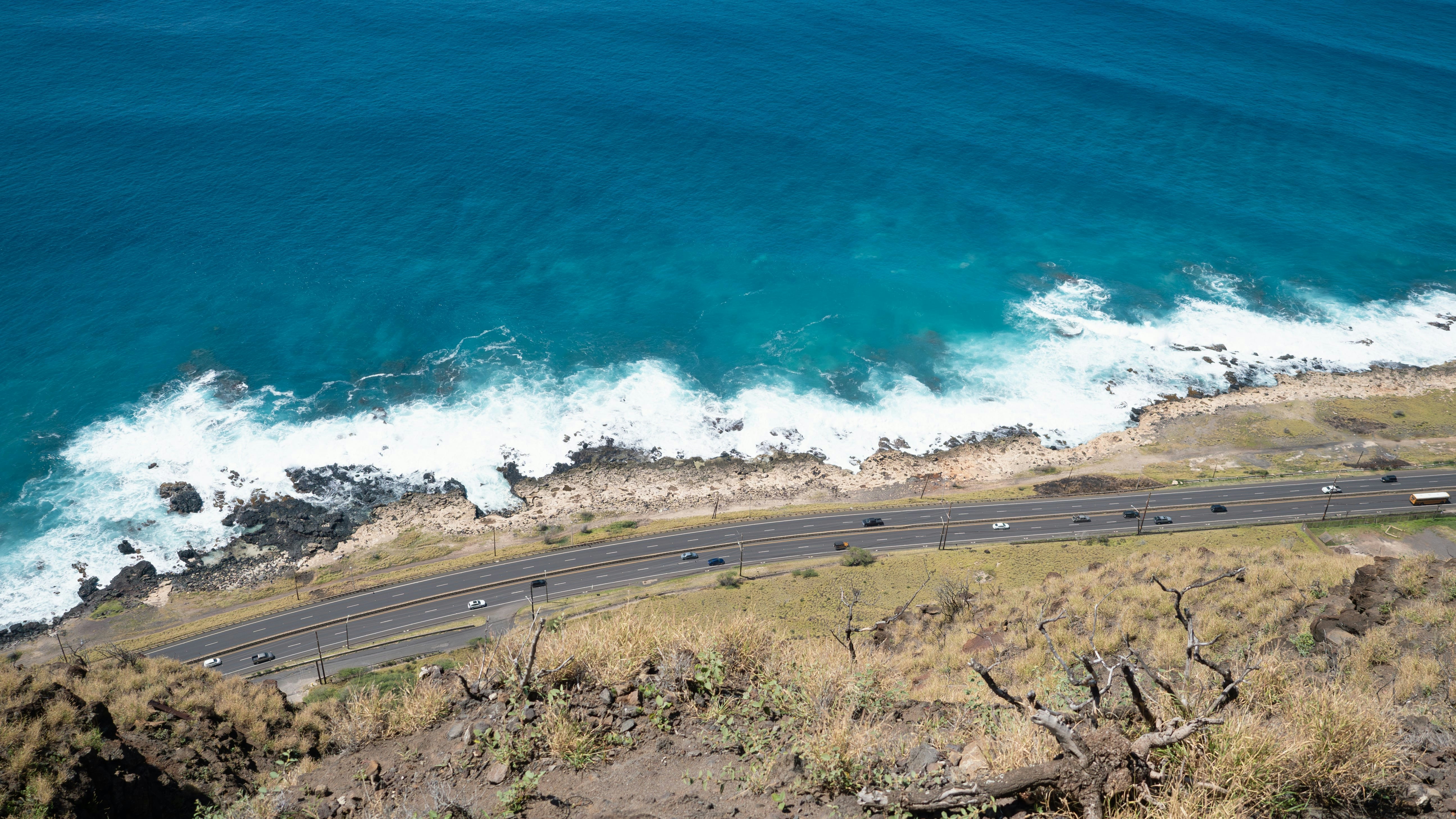 An aerial view of a road near the ocean