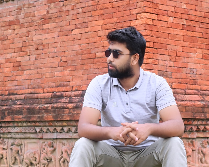 gay man sitting on wooden bench