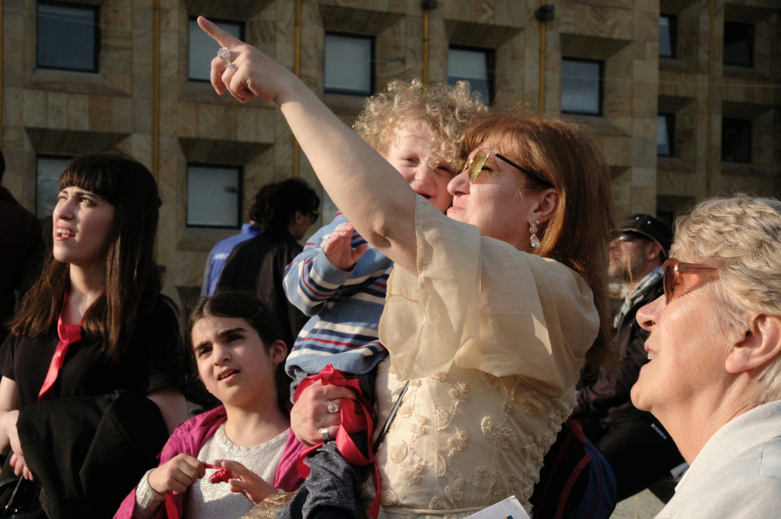 A group of people standing in front of a building