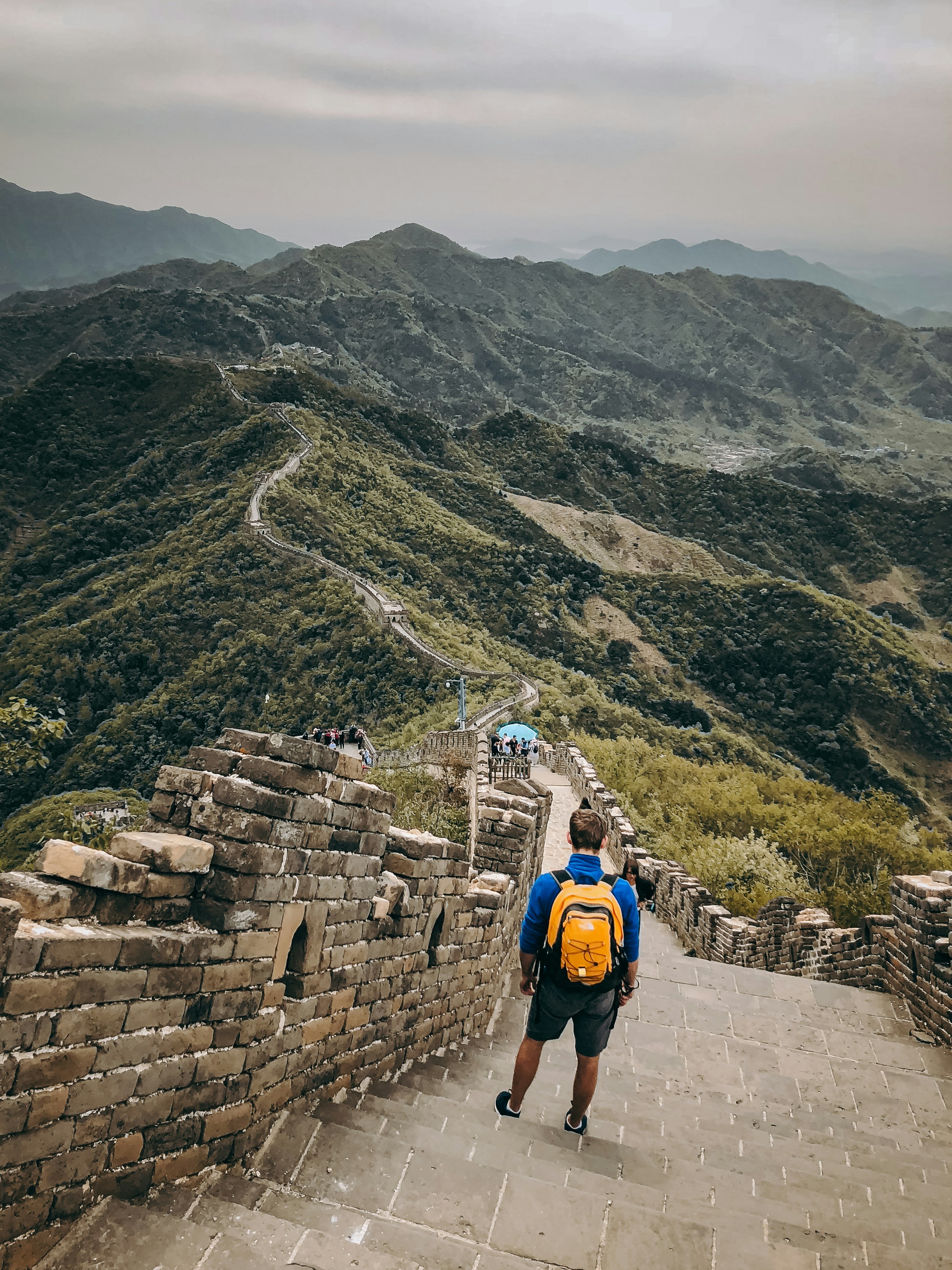 A man with a backpack walking up a mountain