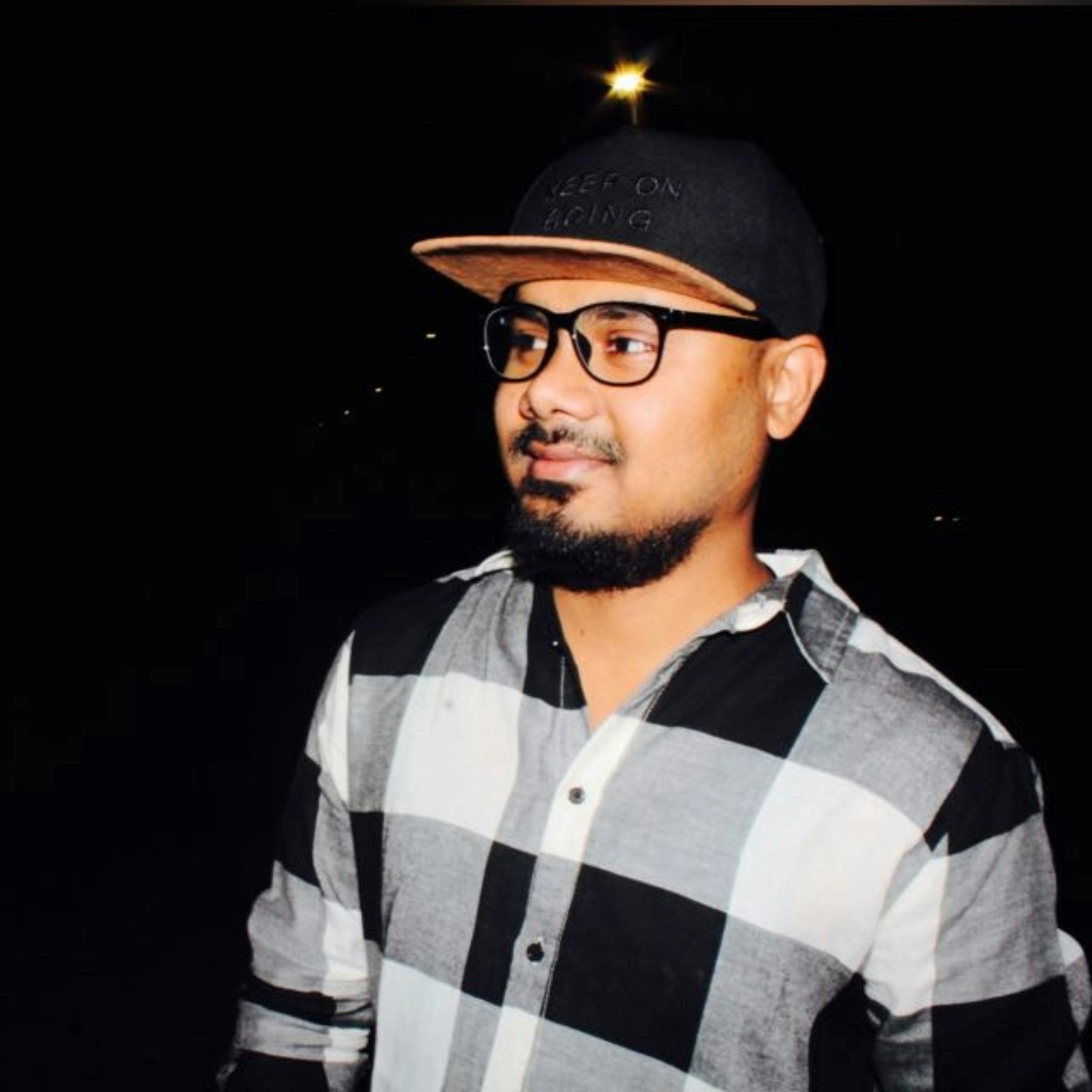 A man wearing a black and white checkered shirt