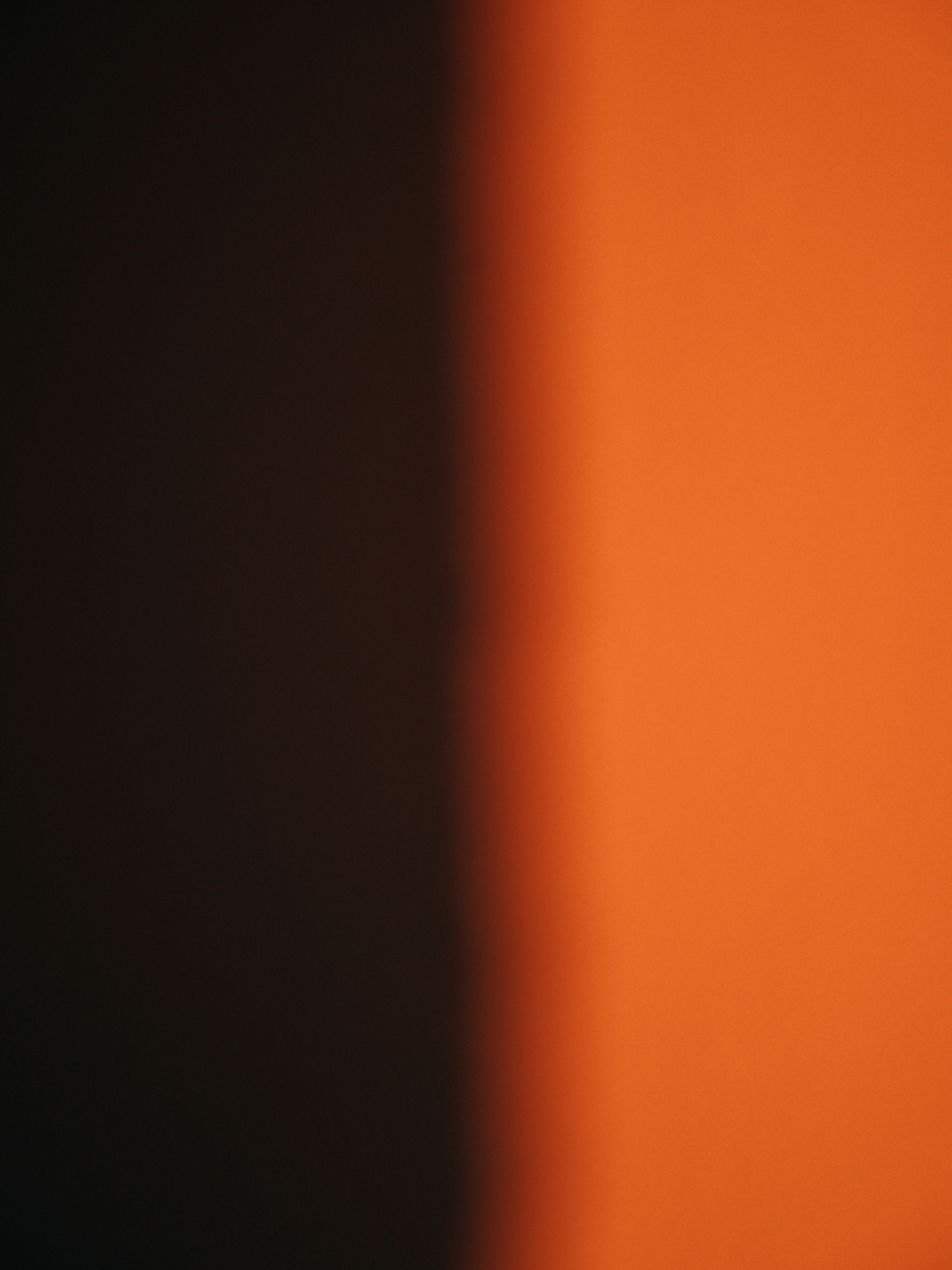 A blurry photo of an orange wall