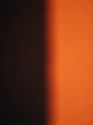 A blurry photo of an orange wall