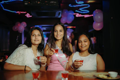 A group of women standing next to each other at a table