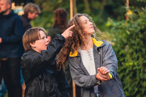 A woman helping a child with her hair