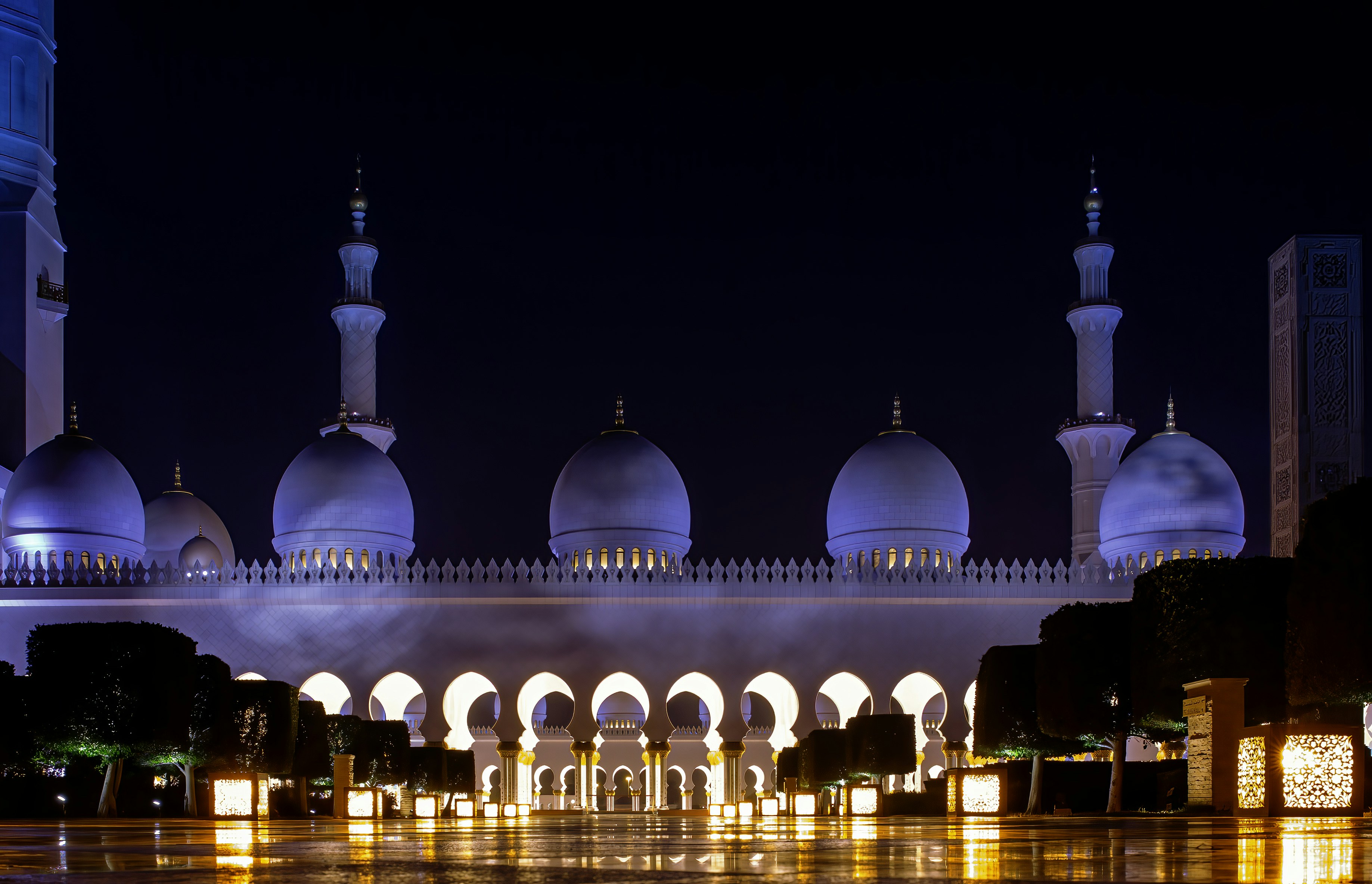 A large white building with a fountain in front of it