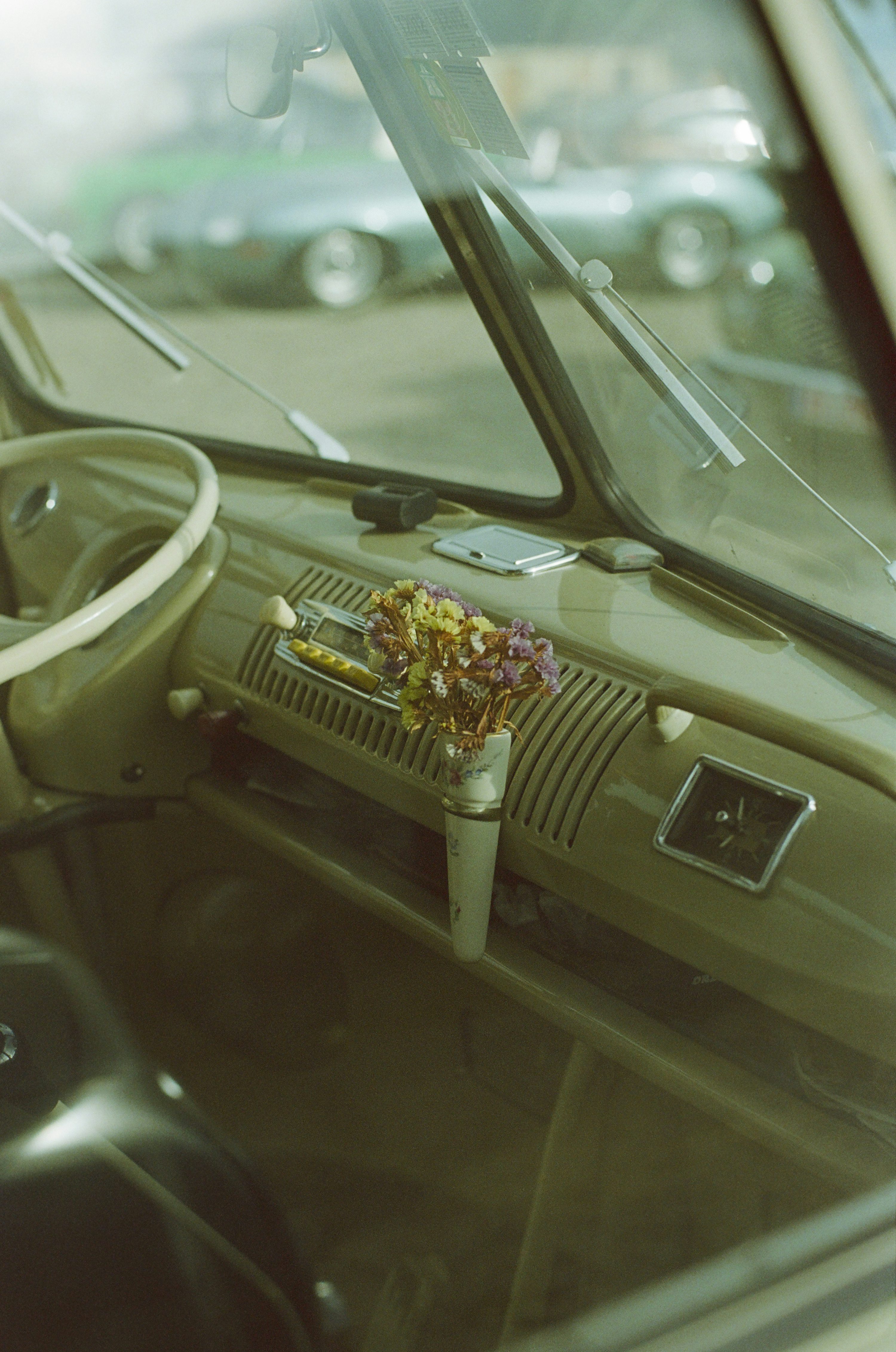 The interior of a car with a steering wheel and dashboard