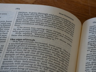 An open book on a table with a cell phone